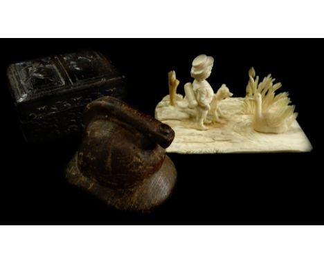 A late 19thC carved ivory figure group of a young boy, a dog and a swan, on a rectangular base, possibly Dieppe 10 cm long, a