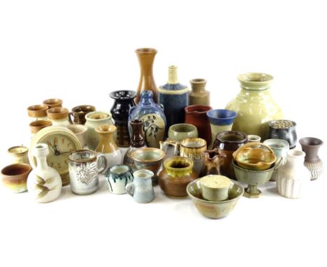 A large collection of Studio pottery, to include an alarm clock, a Mary Pancost carafe with three goblets, etc.