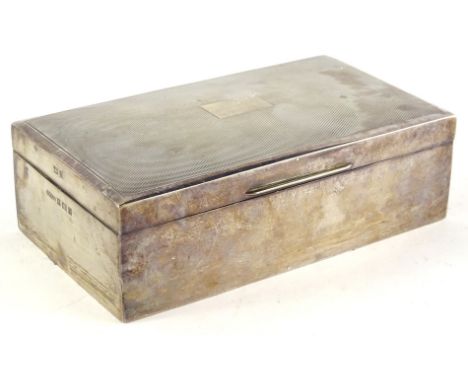 An Elizabeth II rectangular cigarette box, the engine turned lid with a vacant cartouche enclosing a cedar lined interior, Bi