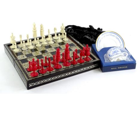 A late 19thC/early 20thC Chinese red stained and plain ivory chess set, with later mother of pearl and bone inlaid box, a lad