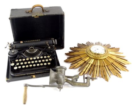 A Sunburst wall clock, stamped Bravingtons Limited London to the paper dial, a mincer and an Underwood standard portable type