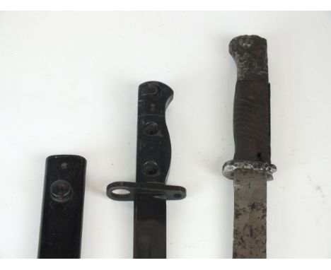 A British Lee Enfield LA13 bayonet and scabbard, stamped D66 to the forte and grip, numbered 9600257, blade length 20cm, over