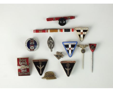 A group of German Third Reich badge and stick pins, badges and tinnies including an NS 'Deine Hand Dem Handwerk' badge, two N