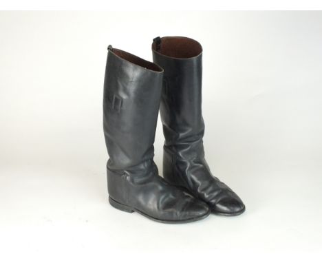 A pair of German WW2 black leather jack boots with interior pulls, no visible markings