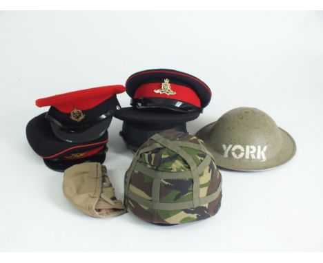 Visor caps including Welsh Guards, Royal Artillery x 2 and Military Police, together with a camouflaged helmet and a WW2 brod