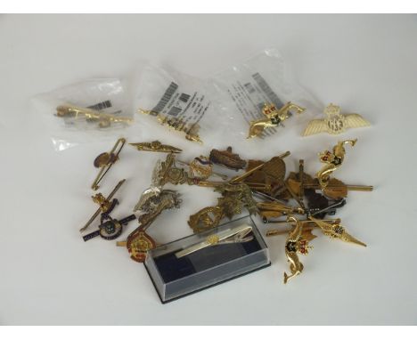 A selection of British and Canadian Air Force brooches to include an R.A.F carved brooch, a Canadian metal Mizpah brooch and 