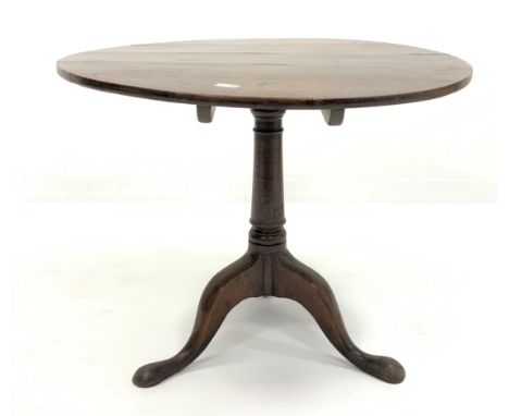 Georgian oak circular tilt top occasional table, raised on ring turned column and triple splay supports with pad feet, D84cm,