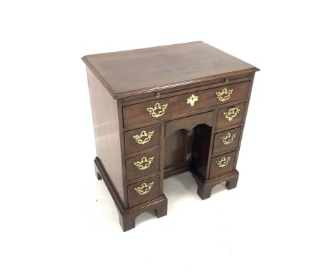 George III mahogany kneehole desk, brushing slide over one long drawer, one concealed drawer, one arched panelled cupboard an