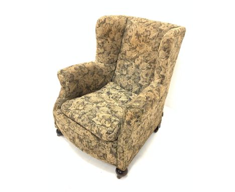 Victorian wingback upholstered armchair, with loose cushion, raised on walnut bun front supports and castors, W90cm - Conditi