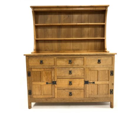 'Acornman' Yorkshire oak dresser, with two height plate rack over five drawers and two panelled cupboards, each enclosing a s