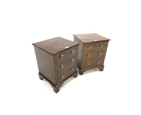Pair of mahogany bedsides, with hinged tops revealing plain interiors, over three faux drawers, raised on shaped bracket supp