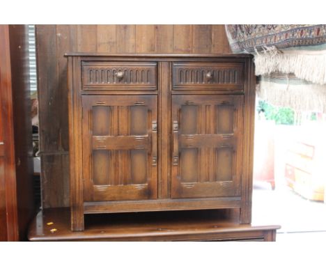 An Ercol dark oak sideboard, together with a further Ercol oak side cabinet (2)