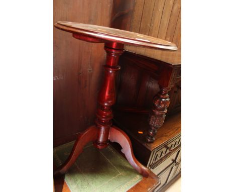 A 19th Century mahogany pedestal tripod table, having an elm base with three legs