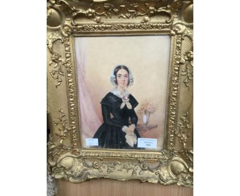 British School, circa 1840, portrait of a you lady, half length standing, wearing a lace bonnet, indistinctly signed l.r., wa