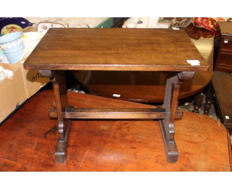 An Arts and Crafts oak coffee table, with trestle type supports, together with a small mahogany tripod wine table (2)