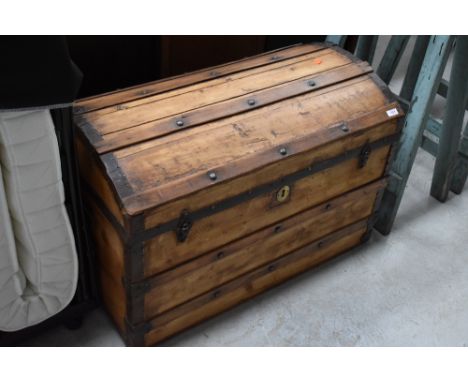 A traditional wooden dome topped trunk, with metal strapping and stud work stripe lined interior, approx. width 83cm