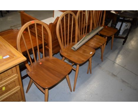 A set of four vintage , Ercol style (not labelled but stamped LE2056) , hoop and stick back kitchen chairs, light to mid stai