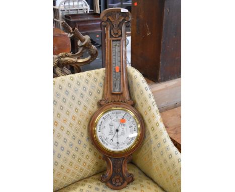 A late 19th/early 20th Century oak cased aneroid barometer of banjo form, dial marked Admiral Fitzroy, silvered thermometer t