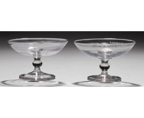 TWO ENGLISH GLASS PATCH STANDS, LATE 18TH C the shallow saucer bowl engraved with band of flowers and foliage, on knopped ste