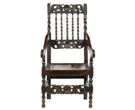 A CHARLES II OAK ARMCHAIR, C1680&nbsp; the back with barley twist supports and carved foliate cross rails with central shell 