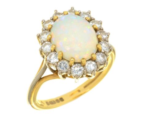 AN OPAL AND DIAMOND CLUSTER RING in 18ct gold, the central opal approx 10 x 8 mm, 6.5g, size N  Light wear consistent with ag