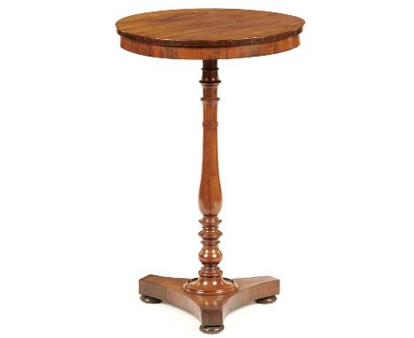 A ROSEWOOD LAMP TABLE, 19TH C&nbsp;the baluster pillar on platform and bun feet, 73.5cm h, 46cm diam  Top of lighter colour; 