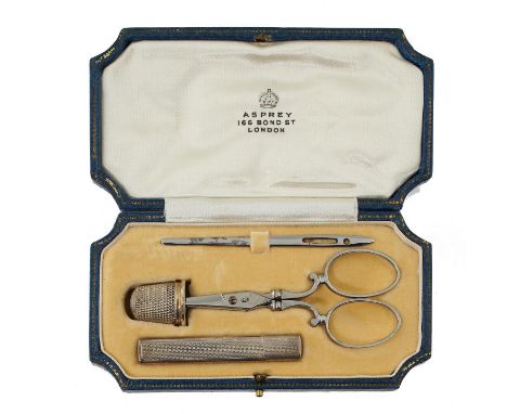 A BLUE LEATHER CASED NECESSAIRE BY ASPREY&nbsp;containing bright steel scissors, bodkin, gilt silver coloured metal thimble a