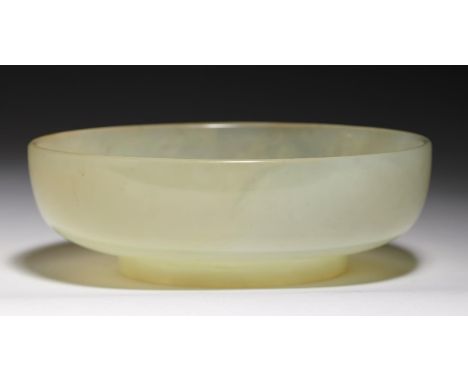 A CHINESE JADE BOWL, POSSIBLY 19TH C on circular foot, 12cm diam and a wood stand Bowl in good condition. Wood stand damaged