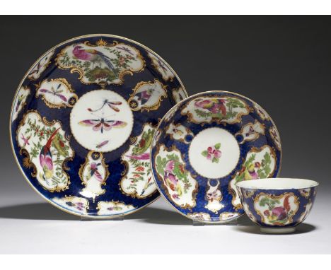 A WORCESTER SCALE BLUE GROUND TEA BOWL, SAUCER AND SAUCER DISH, C1770&nbsp;painted with dishevelled and fancy birds respectiv
