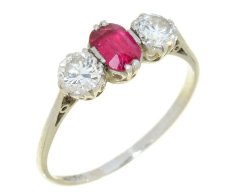 A RUBY AND DIAMOND THREE STONE RING in platinum, 2.8g, size Q  Slight abrasions to ruby table facets. No damage to diamonds. 