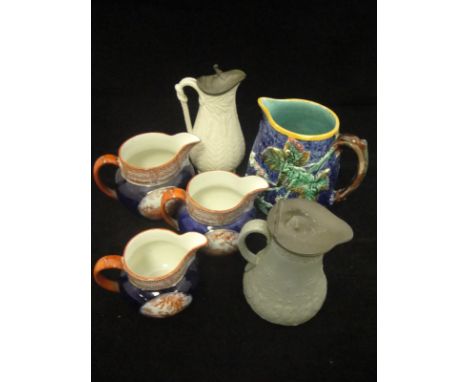 A collection of decorative china wares to include a 19th Century Wedgwood majolica jug relief decorated with flowering and fr