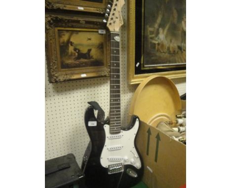 An Elevation Stratocaster Copy electric guitar, together with a Stagg 10 GA practice amp, together with various tutor books, 
