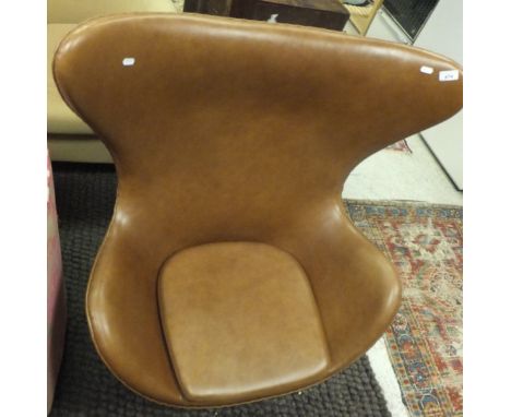 A modern Scandinavian style "egg" chair in the manner of Arne Jacobsen, upholstered in tan leather CONDITION REPORTS Some scu