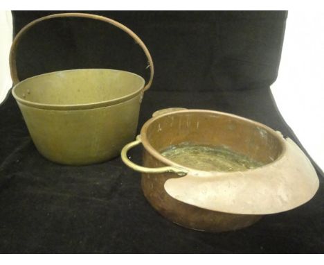 A 17th Century brass saucepan with swing handle, a brass pedestal bowl of flower head form with swing handle, a bell metal ca