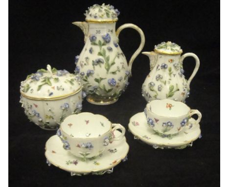 A 19th Century Meissen floral encrusted coffee pot with small jug, bowl and cover and two cups and saucers, each of squash fo