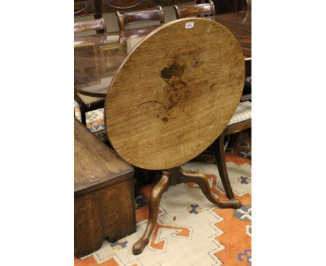 A 19th Century mahogany circular tilt top occasional table raised on turned and ringed column to tripod base