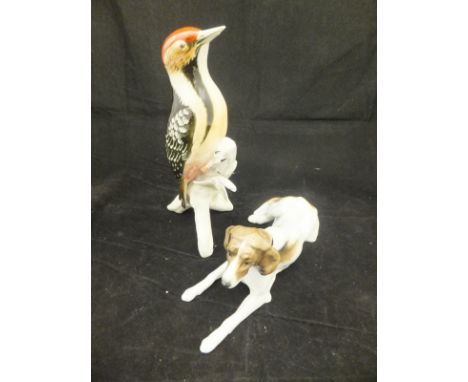 A Karl Ens porcelain figure of a dog, together with a Karl Ens figure of a woodpecker (2) CONDITION REPORTS Dog has some brow