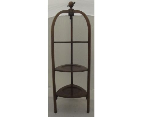 An Edwardian mahogany and satinwood strung three tier cake stand, an early 20th Century stained beech framed doll's cot, a 19