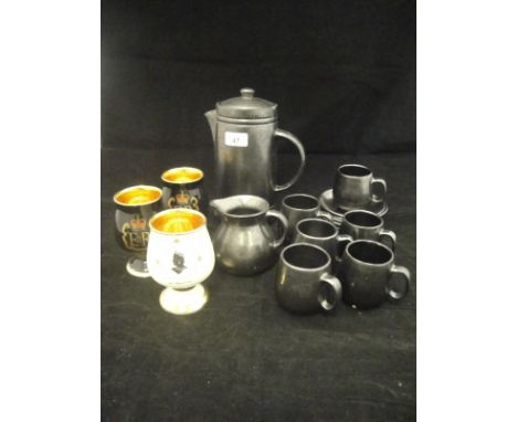 A Prinknash black lustre ware part coffee set comprising coffee pot, six cups and saucers and a milk jug, three Prinknash com