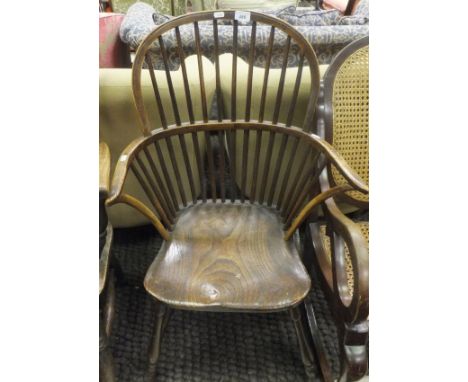 A 19th Century oak and elm stick back Windsor elbow chair with pierced and shaped back splat, on turned and ringed legs unite