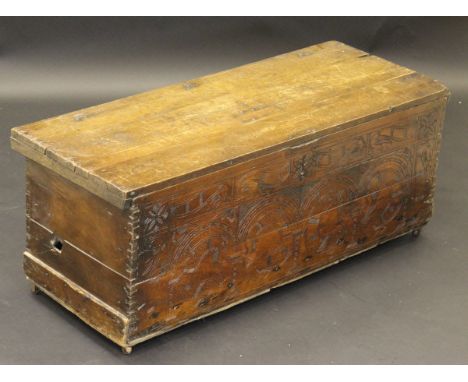 A 17th Century Cyprus chest with planked cypress top, the front panel decorated with low relief carving depicting mythical be