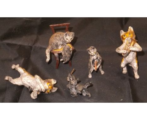 A collection of five painted lead flash metal figures of cats, three playing musical instruments, the other beating a further