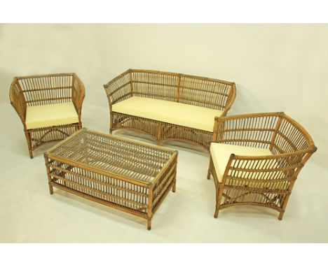A Rattan garden suite comprising a two-seater sofa, two armchairs and a rectangular coffee table with glass top, the sofa mea