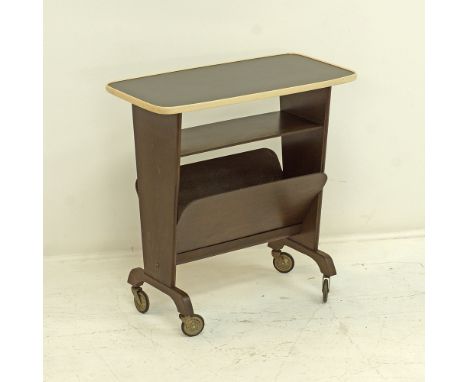 A German 'OPAL KLEIN MOBEL' magazine rack with a black Formica top above a shelf, on castors, marked to the underside, measur