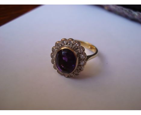 An 18 carat gold amethyst and diamond cluster ring. 