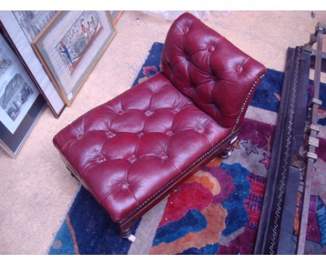 A early Victorian mahogany gout stool, upholstered in dark red button back and brass studded leather, with double adjustable 
