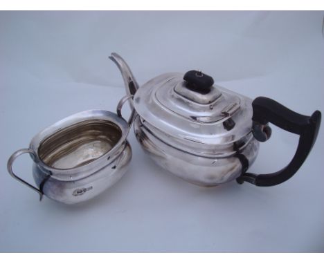 A silver teapot and a silver sugar bowl, both Viners Ltd, Sheffield, 1925, the teapot with ebonised handle and finial,  appro