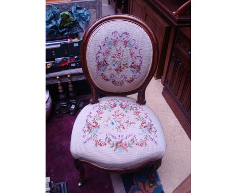 A Victorian walnut salon chair, with moulded frame, oval back and serpentine stuffover seat, raised on cabriole legs and cast