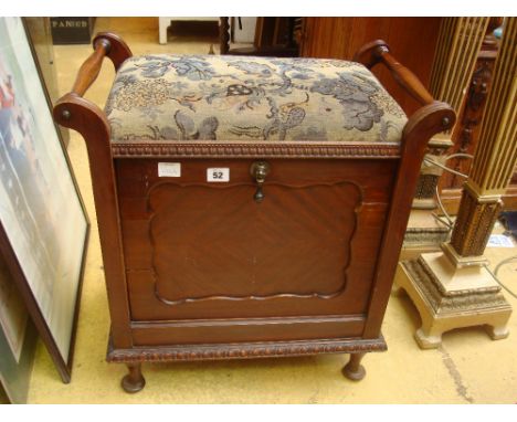 An Edwardian walnut piano stool with machine made tapestry covered seat, on box base with fall front sheet music compartment.