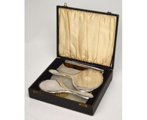 A George V hallmarked silver cased dressing set comprising mirror, brush and silver-capped comb, W G Sothers Ltd, Birmingham 